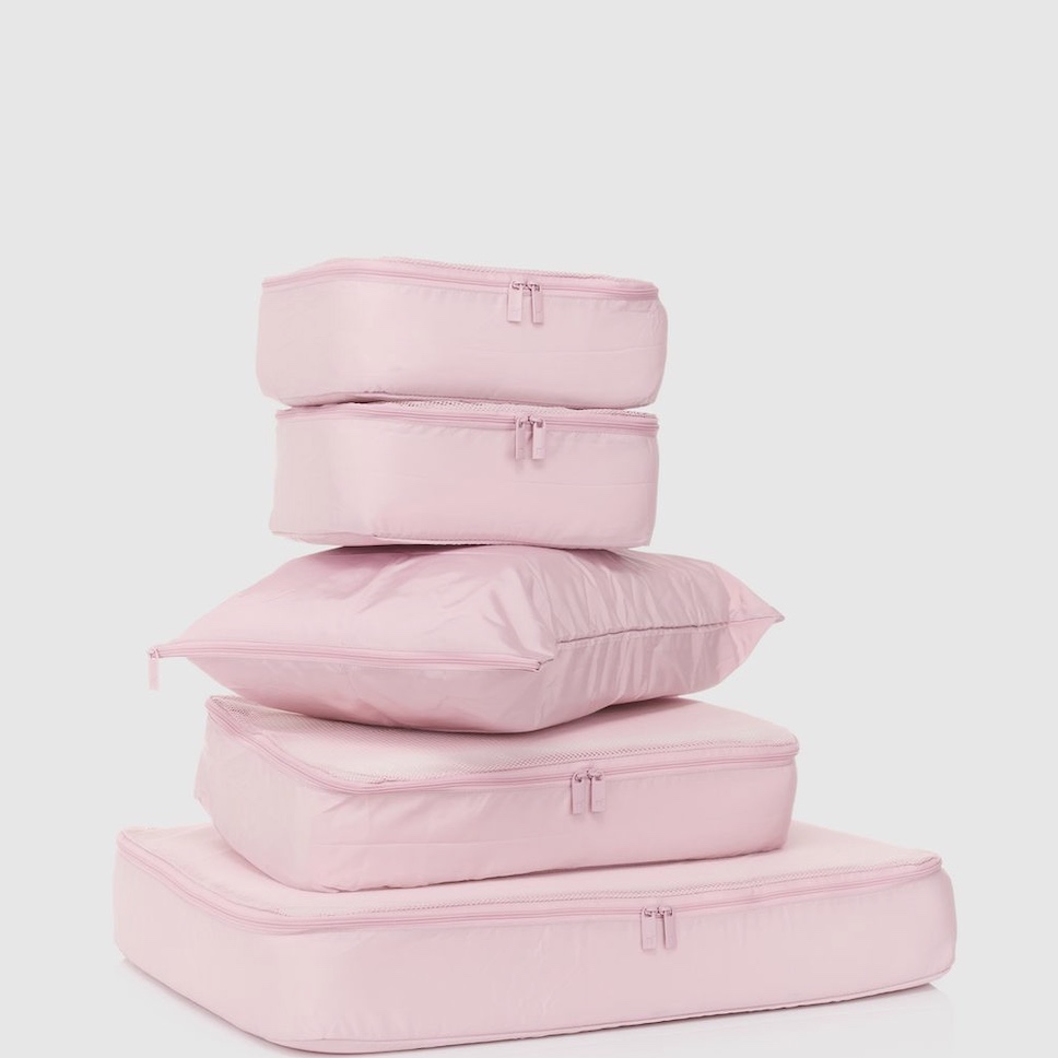 Stack of soft pink packing cubes on a light background